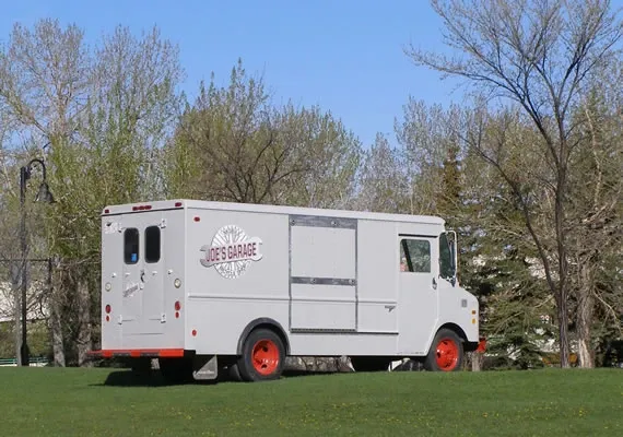 The 1981 GMC-Grumman Kurbmaster arriving on site by the Bow River Pathway