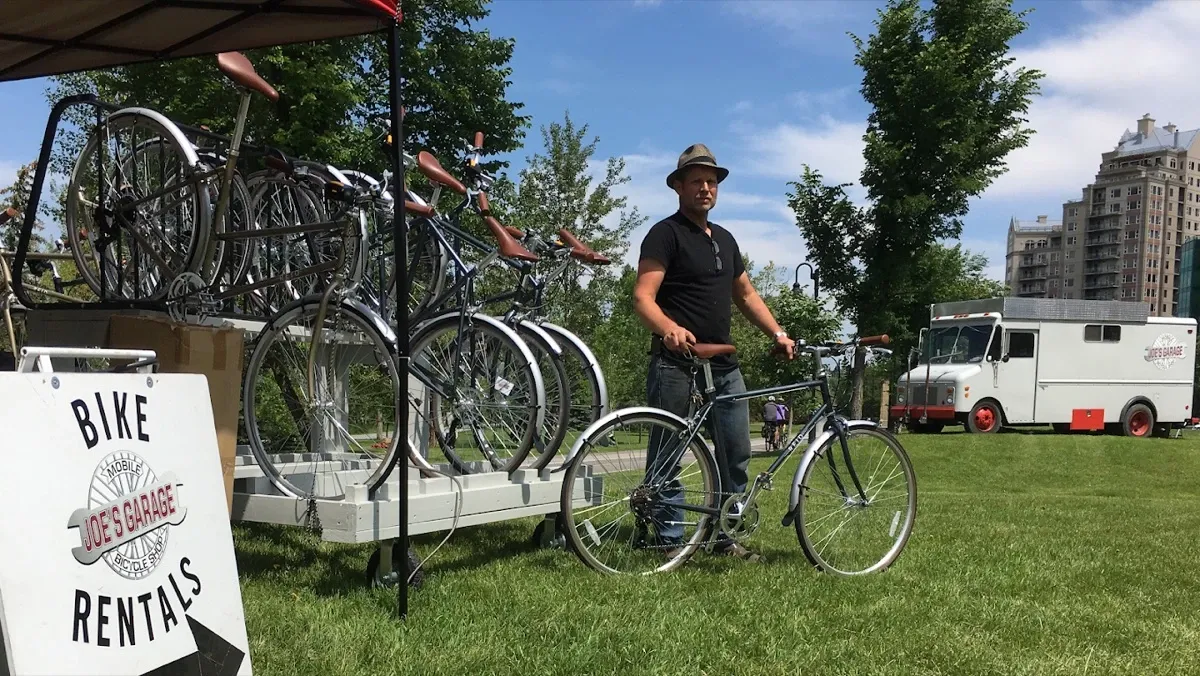 Joe standing with rental bikes on the pathway